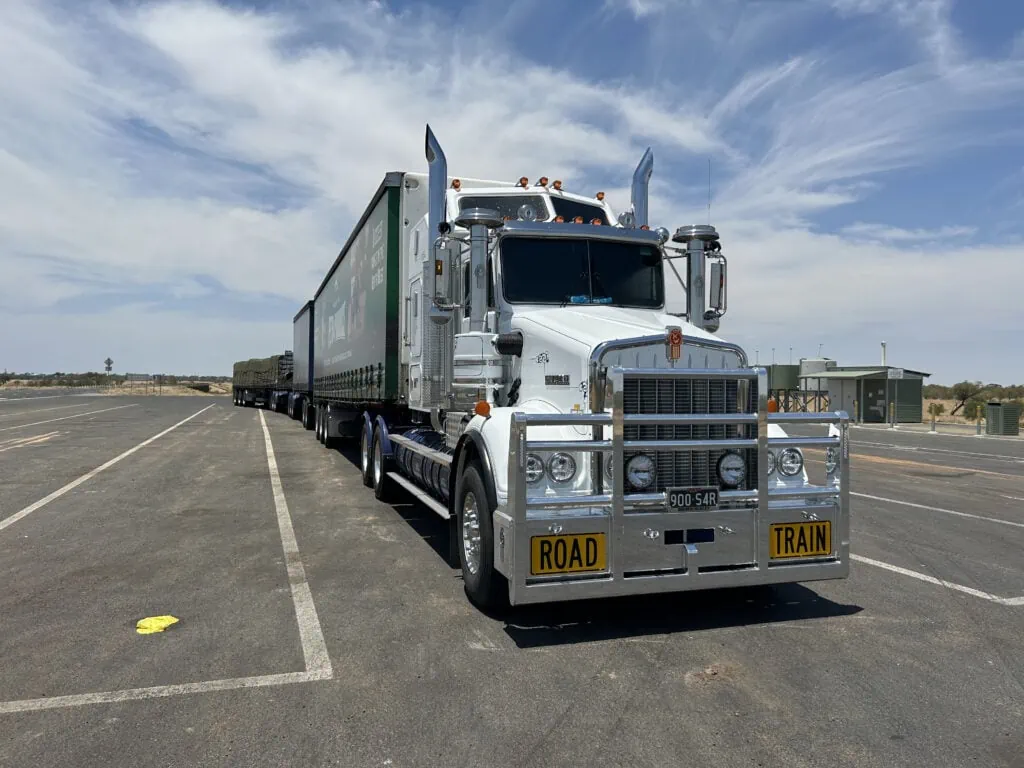 large white freight forwarding truck pulled over at a stop over on the highway